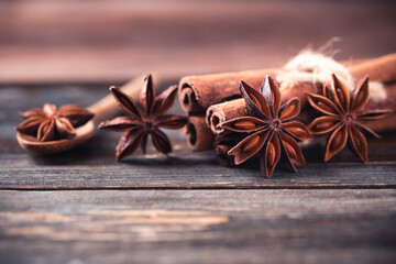 Star anise and cinnamon stick on wooden background
