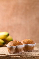 Homemade banana cupcake and banana fruit on wooden background
