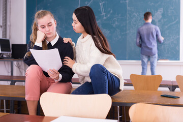 Chinese student teenage girl comforting female friend upset because of bad test result