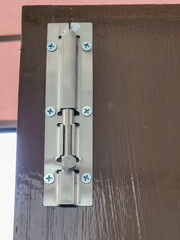 Sliding door lock or latch on wooden door.