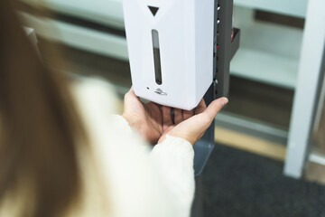 Cleaning, washing hands using automatic sanitizer dispenser concept. Today people lifestyle...