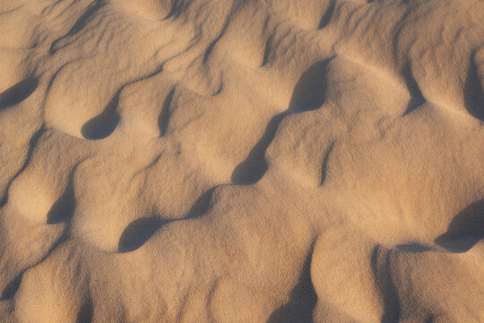 Sand patterns of the Arashi Dunes illuminated in the morning sunlight in Aruba.