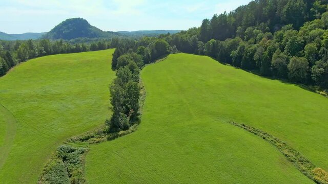 Aerial view, high angle view with a drone, flying backward, revealing the surrounding scenery
