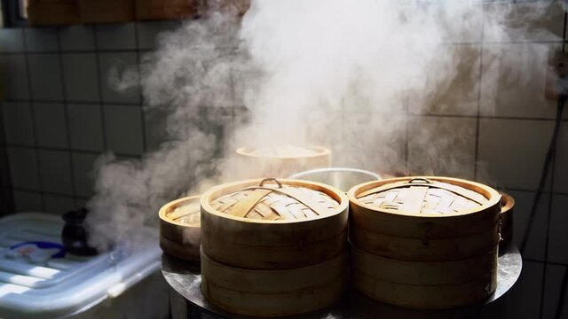 Slow motion of steaming steamed buns bamboo steamer in the breakfast shop kitchen