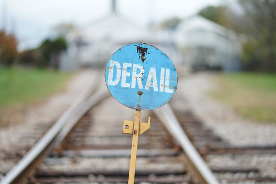 "derail" sign on a railroad