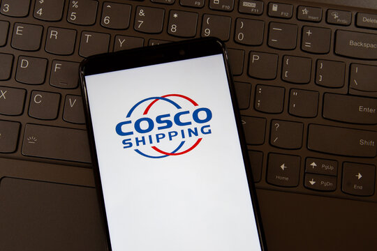 Toronto, On, Canada - December 19, 2021: COSCO logo on the  smartphone screen on a keyboard. China Ocean Shipping Company is a shipping and logistics services supplier. 