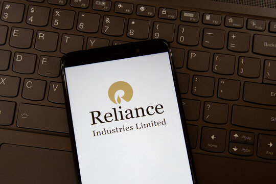 Toronto, ON, Canada - December 19, 2021: Reliance Industries Limited logo on the smartphone screen on a keyboard. State Bank of India is an Indian multinational public sector bank and financial servi