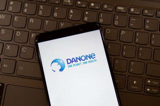 Toronto, On, Canada - December 19, 2021:  Danone logo on smartphone screen on a keyboard. Danone S.A. is a multinational food-products corporation.  