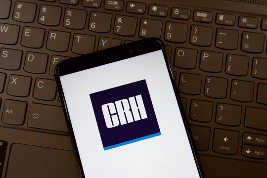 Toronto, On, Canada - December 19, 2021:  CRH logo on smartphone screen on a keyboard. CRH plc is an international group of diversified building materials businesses.