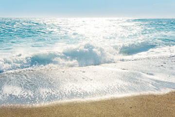 sea surf on a beach on a windy sunny day