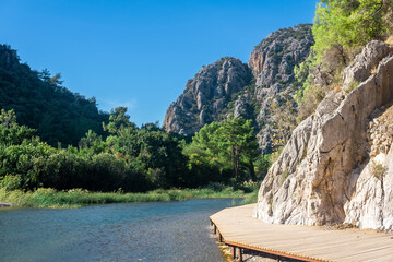 ecological trail along the cliff along the river bank in the tropical mountainous area