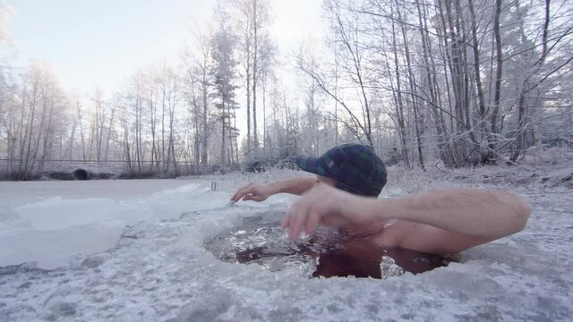 The ice bather finishes his practice and steps out of the ice hole