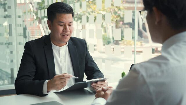 Manager and employee interview concept with handshake after talking about contract signing.