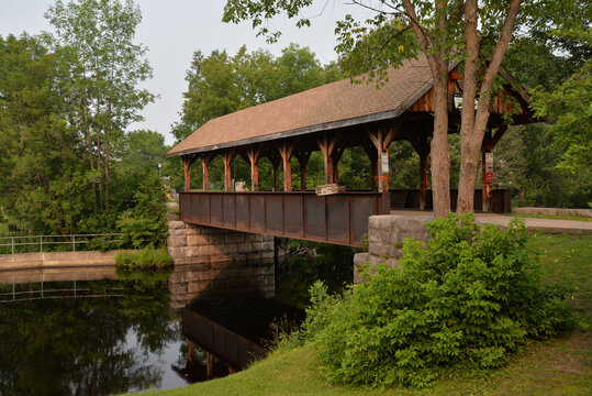 Wooden bridge surrounded by green trees in Killaloe, Ontario Canada