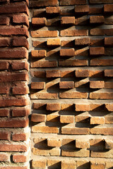 terra cotta brick wall shined by morning sunshine.