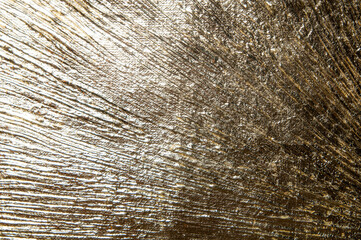 area of radially crumpled gold patina, flare effect, short focus