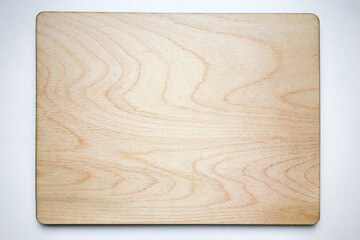 Clean wooden board on white isolate. Place for the inscription. A rectangle of plywood on the table.
