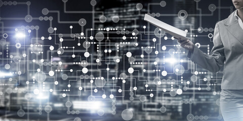 Close of businesswoman against night cityscape background and technology concept