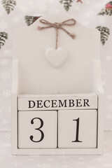 December 31th, New Year’s Day. Day 31 of month, date calendar on winter background.  White block calendar present date 31 and month December, winter time, New year, 