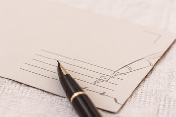 A blank postcard and a pen, fountain pen on white background. Copy space
