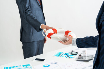 Business persons holding small lifebuoy together