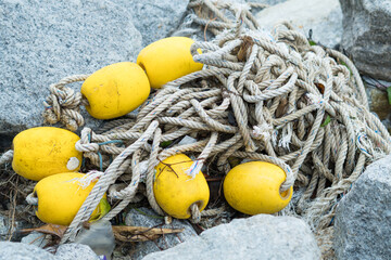 Close up view of old fishing net washed ashore on the beach. Old rope with stones in Port Dickson...