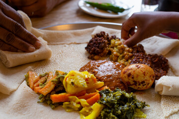 Vegetarian Injera meal with shiro, lentils and egg - obrazy, fototapety, plakaty