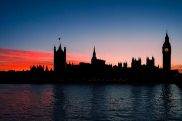 Fototapeta na wymiar Silhouette of Big Ben and Parliament, London against an orange sunset
