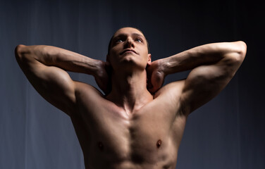 Obraz premium man posing with dumbbells. model in the studio poses, shows muscles, beautiful body relief. spotr, healthy lifestyle