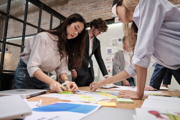 The coworkers' team and colleague brainstormed, discussing a marketing strategy, ideas collaboration, and business project planning at an office's conference table in the staff meeting workplace..