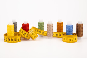 Sewing threads, sewing centimeter or measuring tape, isolated on white background.