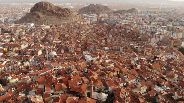 Aerial view of Afyonkarahisar cityscape with similar brownish tiled roofs on residential buildings on sunny winter day, Turkey. High quality 4k footage