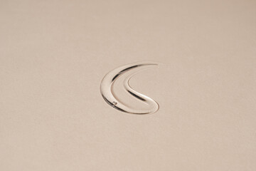 Close up of make up cosmetic gel smudge on neutral dusty beige background. Minimalist beauty...