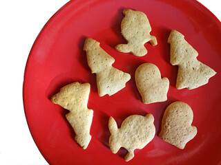 Traditional Christmas cookies without cream on red dish