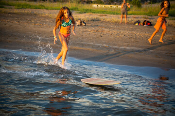 Girl surfing on the seashore