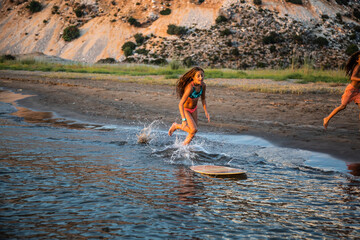 Girl surfing on the seashore
