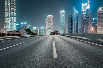 Fototapeta na wymiar Panoramic skyline and modern commercial buildings with empty road in Shanghai