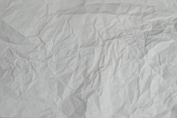 Crumpled white paper background.