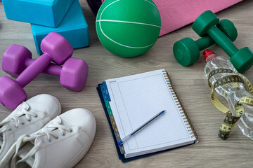 before training, the coach spread out sports equipment and a notebook with a pen.