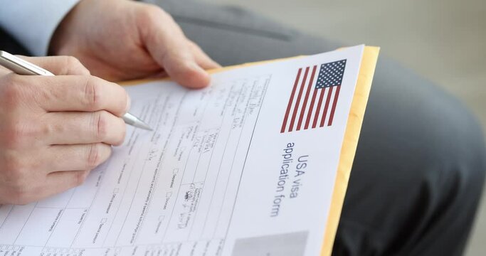 Man fills out American visa application form