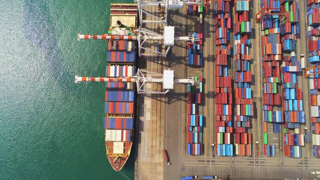 Aerial top view containers ship cargo business commercial trade logistic and transportation of international import export by container freight cargo ship in the open seaport.