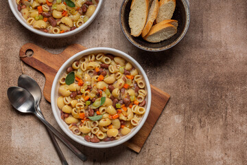 Pasta e fagioli is a typical dish of traditional Italian cuisine made with short pasta and beans, with celery, carrot, onion, and herbs.