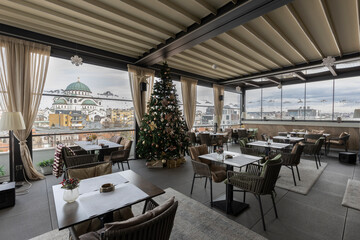 Interior of an empty restaurant with Christmas tree