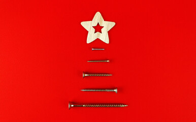 A small tree made of screws and a wooden star. Symbol of the new year