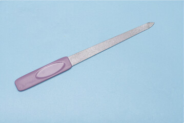 pointed long pink nail file blue background
