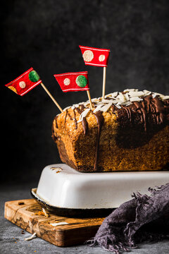 Vanilla cake with chocolate sauce and flags on top of baking mold