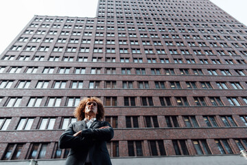 Confident businessman with arms crossed at Potsdamer Platz