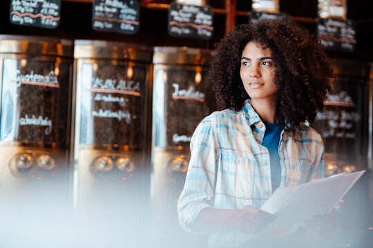 Businesswoman with document at coffee roastery