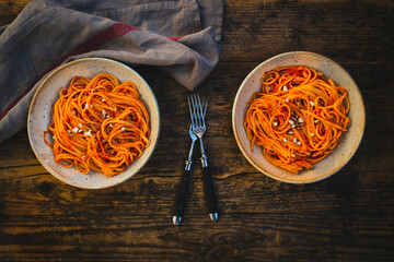 Studio shot of two bowls of vegan linguini with sauce