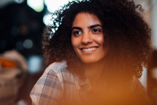 Young businesswoman day dreaming in coffee roastery